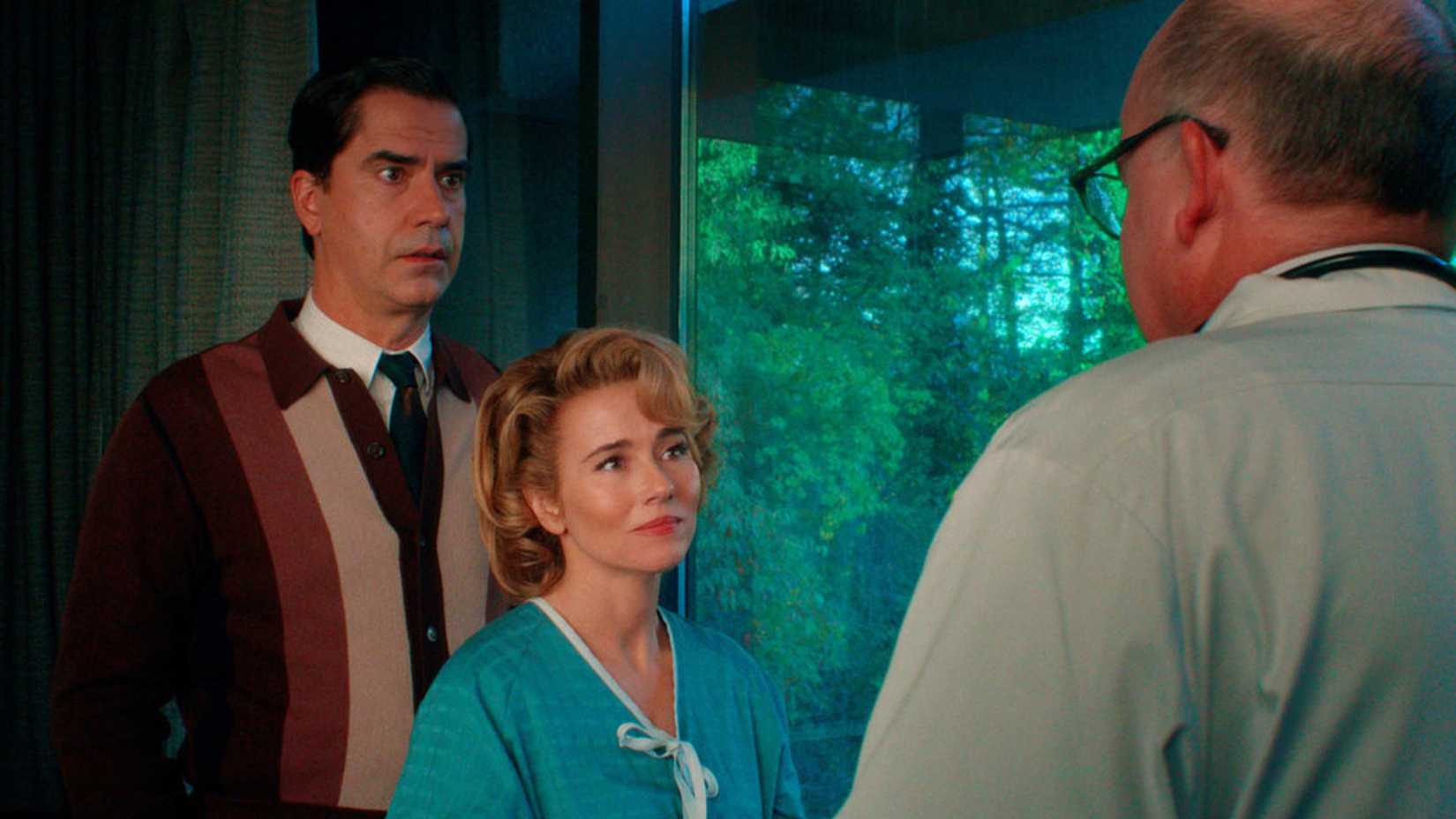 Elias and Pamela stand looking at a doctor in Crystal Lake episode 7