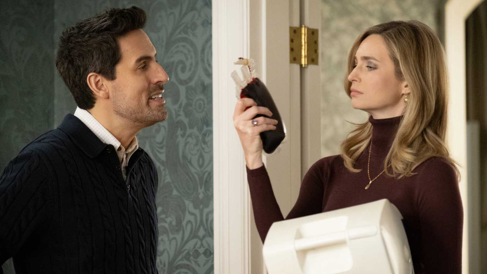 Charles (Ed Weeks) and Liz (Allegra Edwards) looking at a blood bag in Eternally Yours season 1, episode 1.