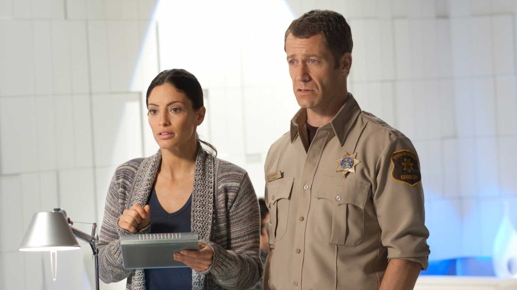 EUREKA, (from left): Erica Cerra, Colin Ferguson, 'Friendly Fire', (Season 5, ep. 504, aired May 7, 2012), 2006-2012. photo: Eike Schroter /