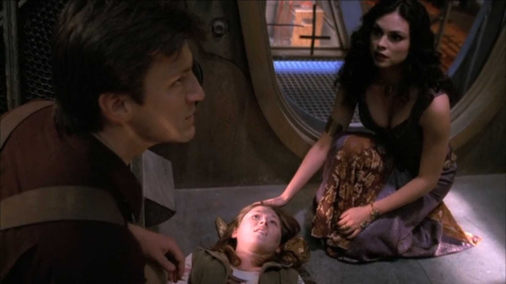 Mal and Inara Standing Over Kaylee in the Firefly Pilot