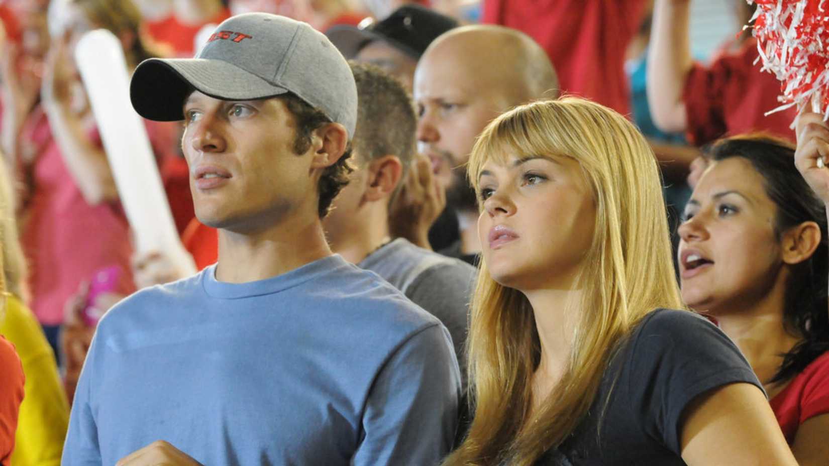 Matt Sarecen and Julie Taylor in the stands in Friday Night Lights