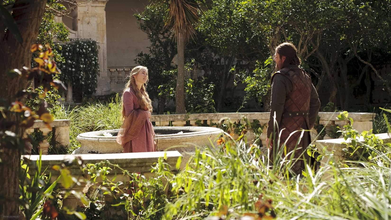 Cersei (Lena Headey) talking to Ned Stark (Sean Bean) in a garden in Game of Thrones.