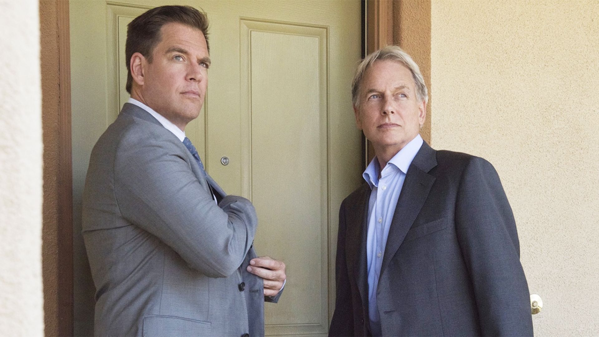 Gibbs and Tony standing together by a door in an NCIS still