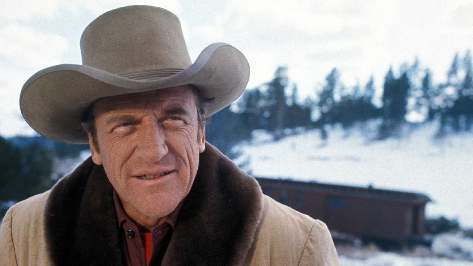 James Arness as Marshal Matt Dillon standing in the snow in Gunsmoke.
