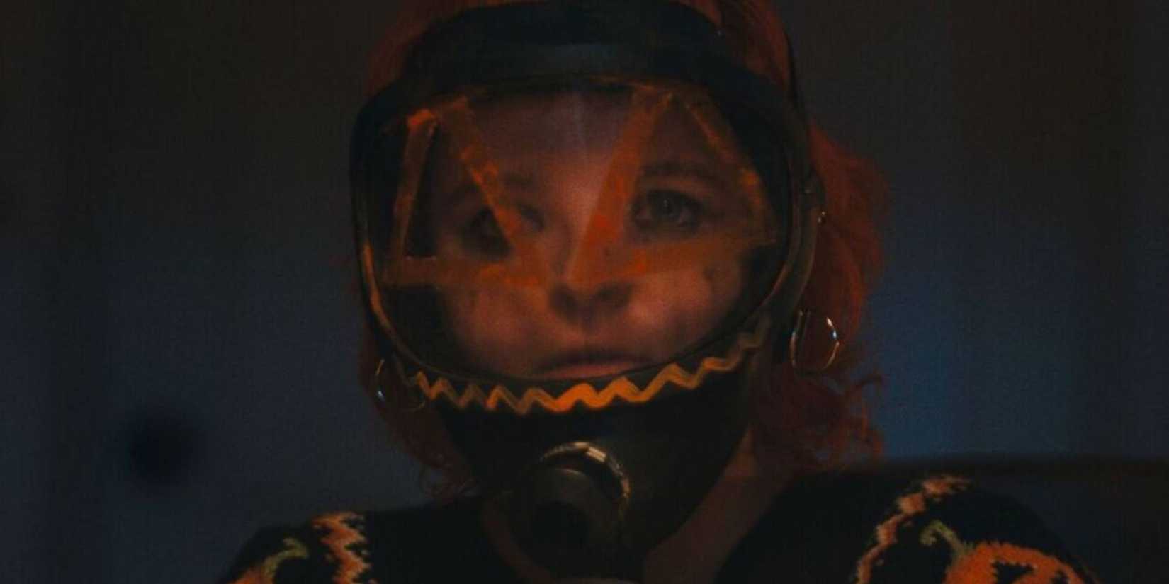 Hallowarrior image of a person wearing a suit with a pumpkin face on it 
