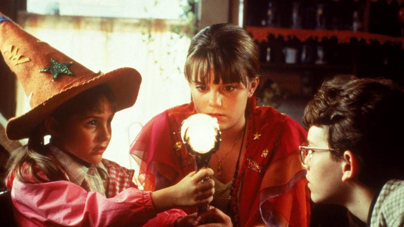 The kids standing around a staff in a Halloweentown 1998 image