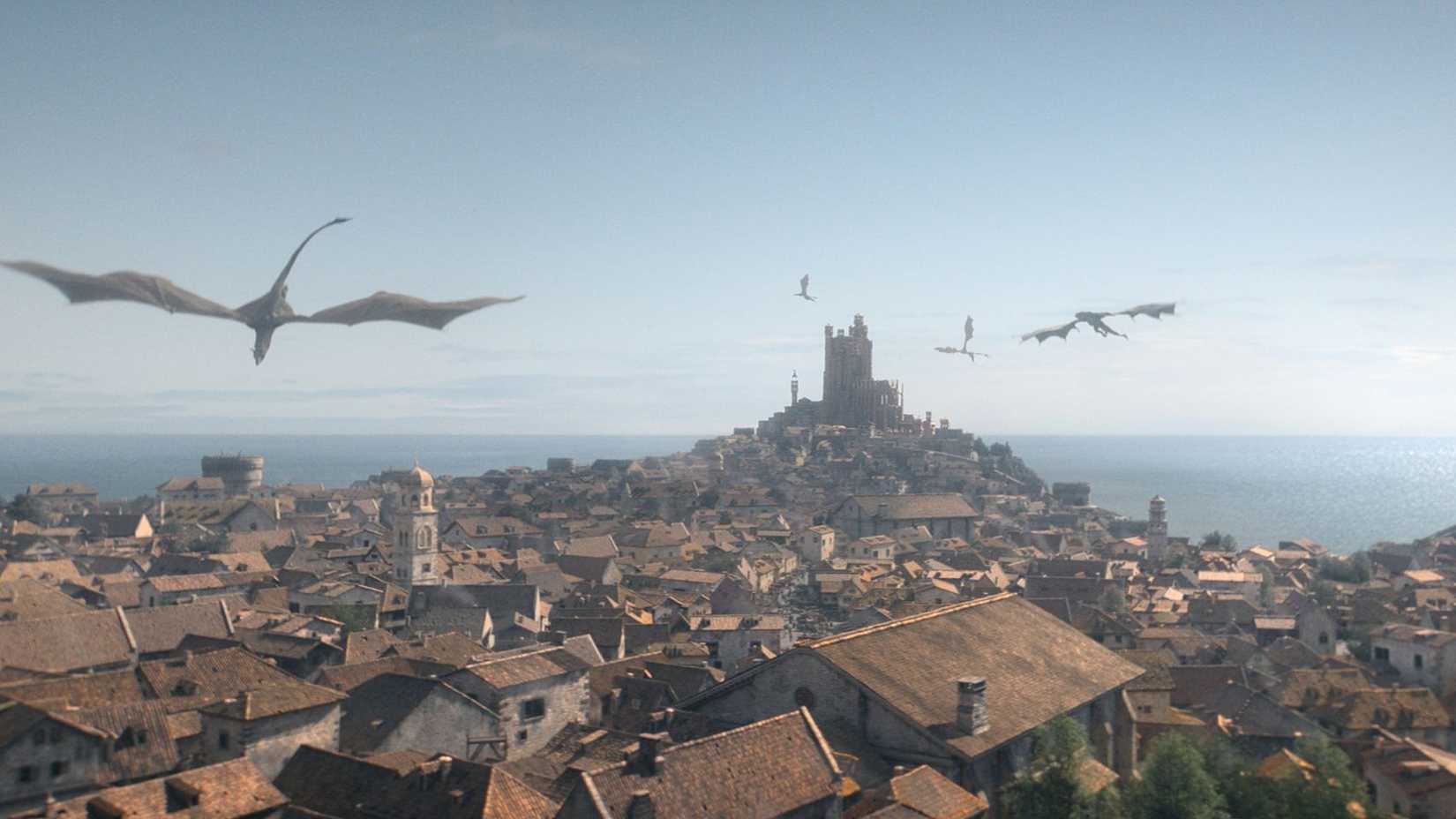 Dragons flying over King's Landing in House of the Dragon.