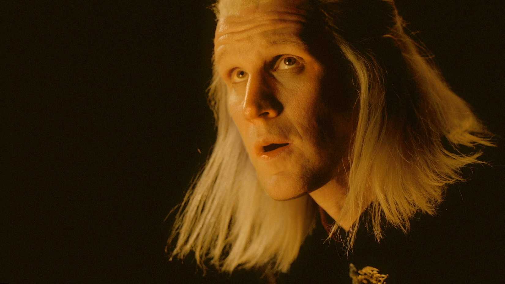 Matt Smith as Prince Daemon Targaryen with his face lit by dragon fire in House of the Dragon.