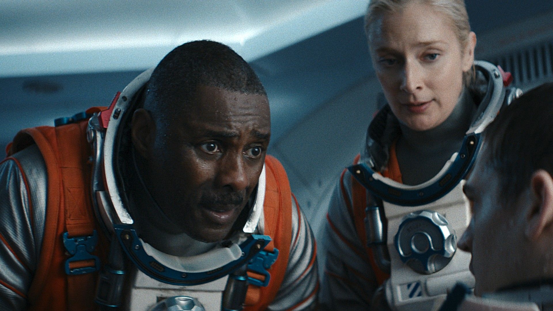 Idris Elba speaking with Hero while Caitlin watches in Above the Below