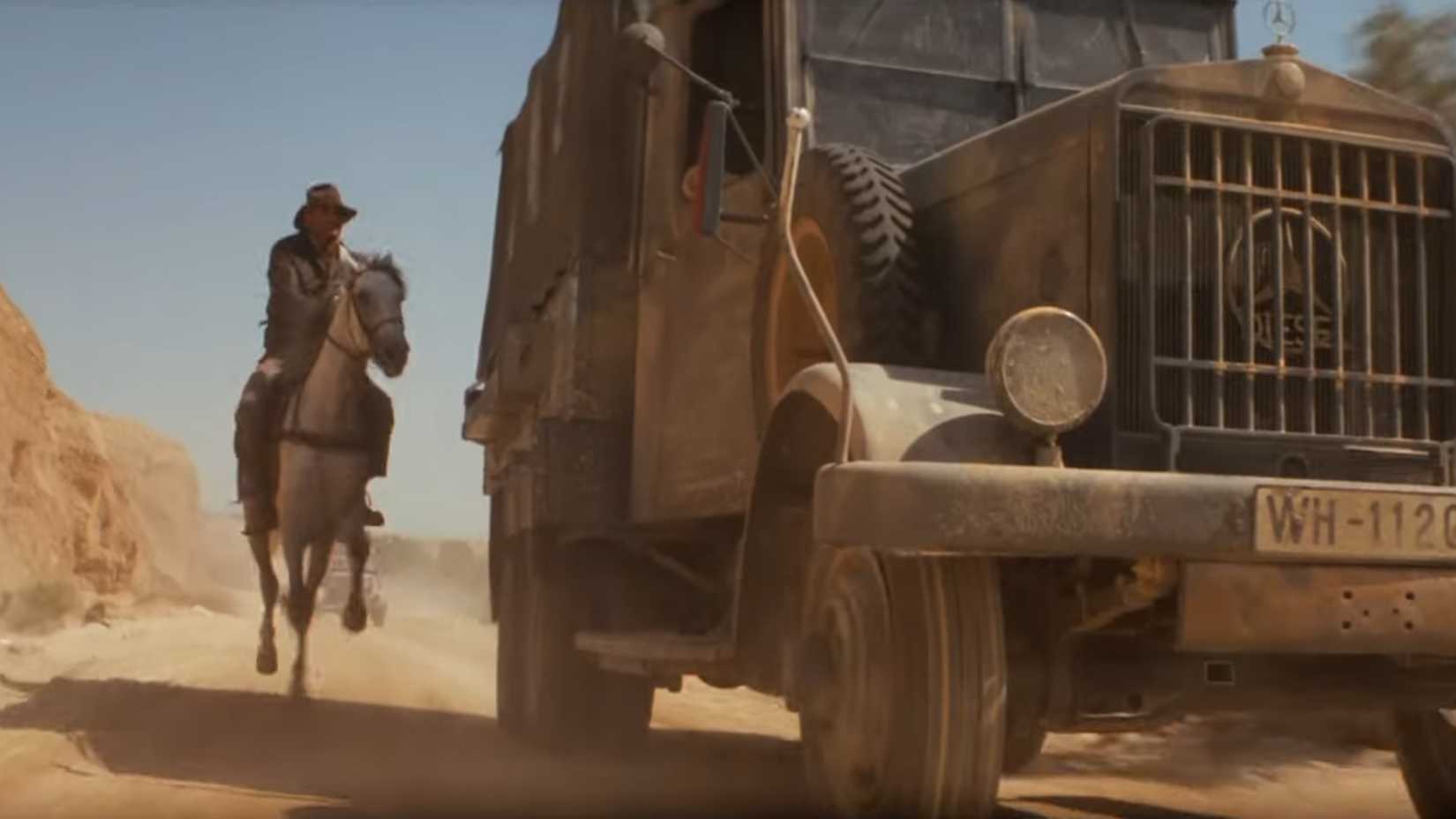 Indy approaching a truck on horseback in Raiders of the Lost Ark