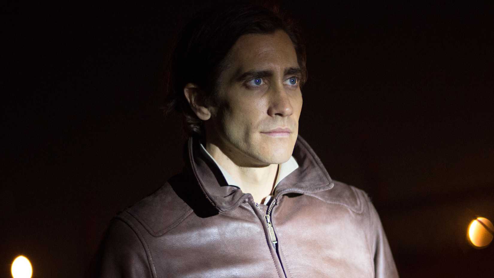 Jake Gyllenhaal with a flashlight shining on him in Nightcrawler