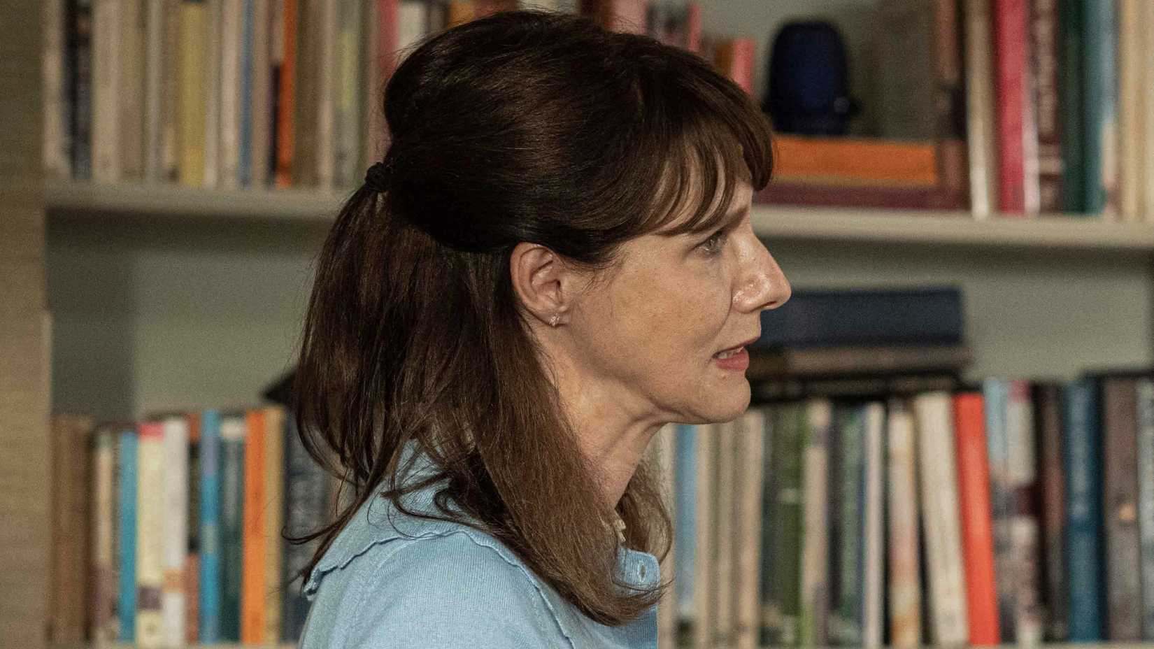 Janice stands in front of a bookshelf in the BBC's Inside Man