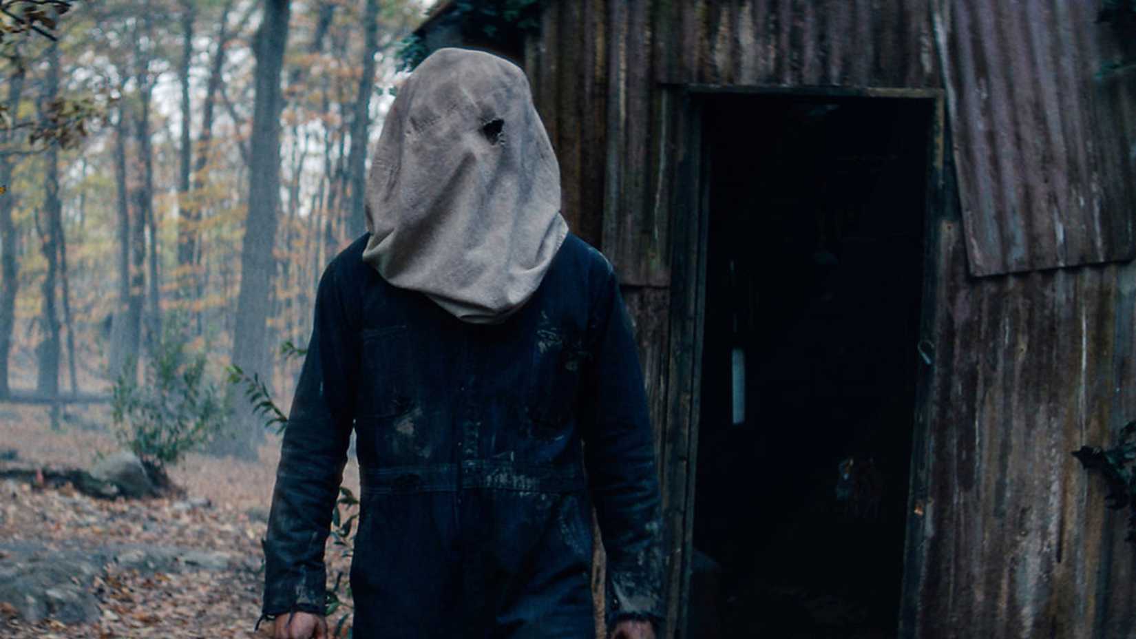Jason has a bag over his head while standing in the woods in Crystal Lake season 1 episode 8