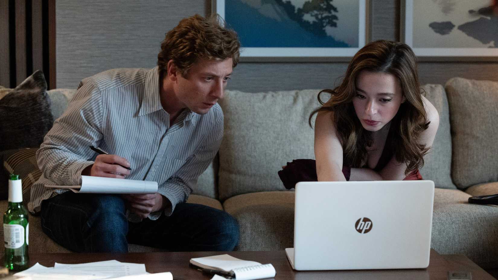 Jeremy Allen White and Mikey Madison looking at a computer screen in The Social Reckoning