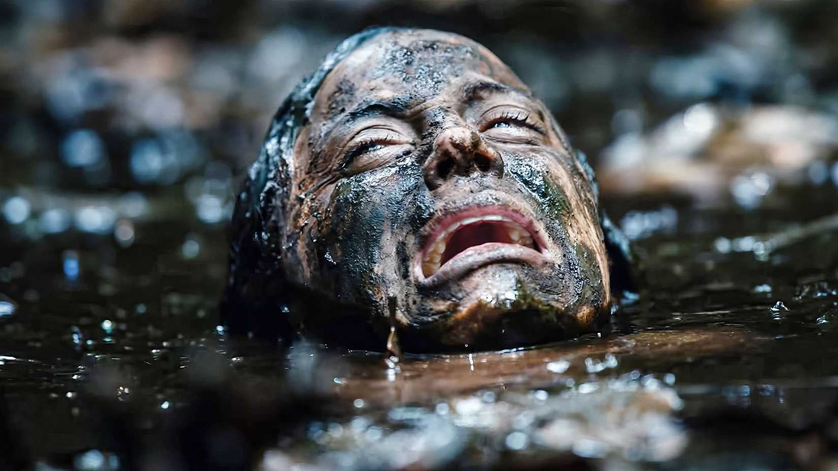 Jessica Rothe screaming submerged neck-deep in muddy water in Beware Boiúna