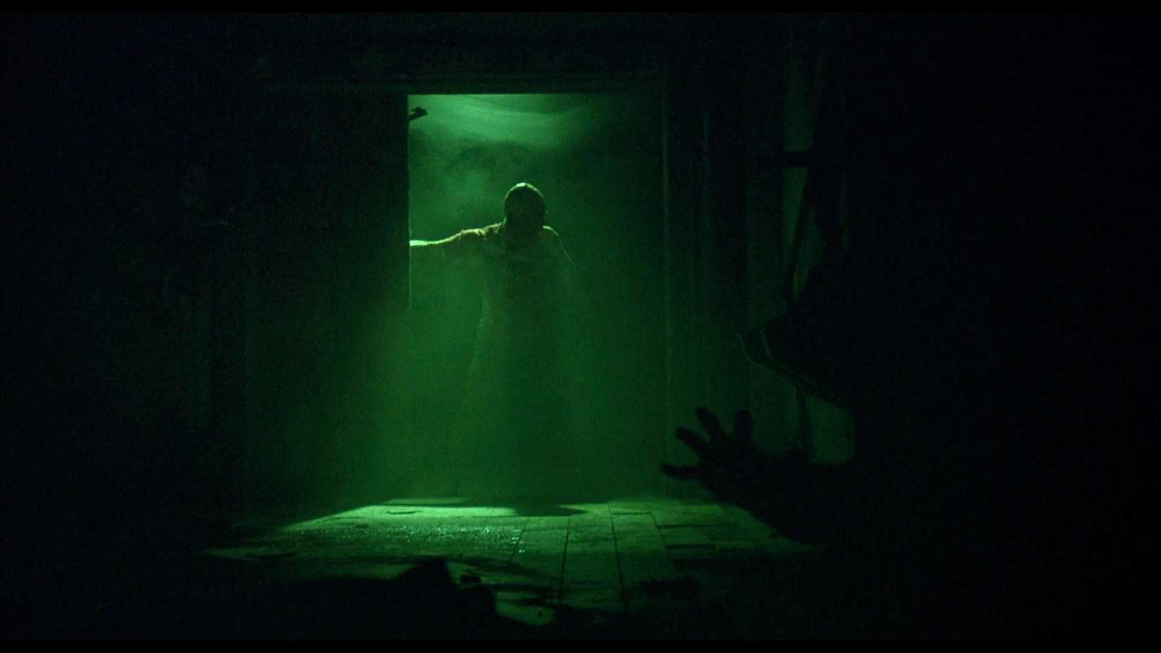 Jigsaw saying "Game Over" and slamming a door as Adam raches out in Saw (2004)