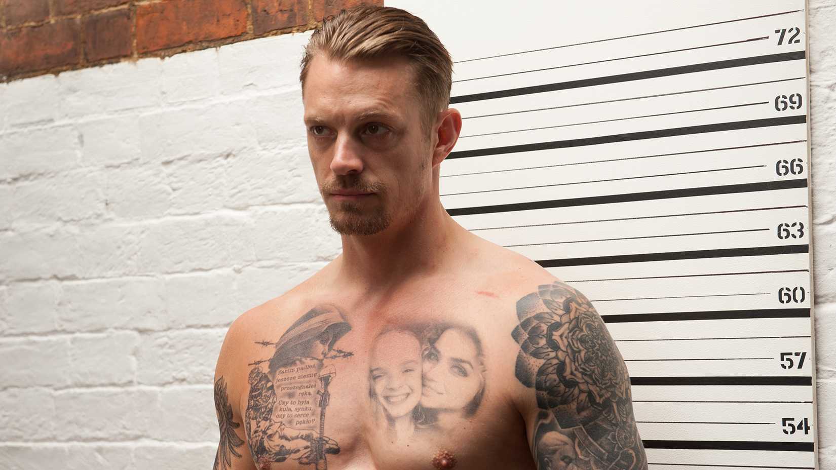 Joel Kinnaman, shirtless and tattooed in a still from The Informer