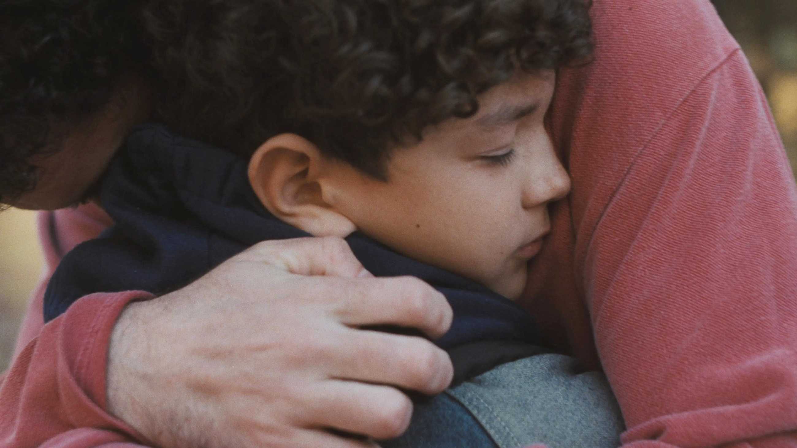 Jordan Firstman and Reggie Absolom hugging in close-up in Club Kid