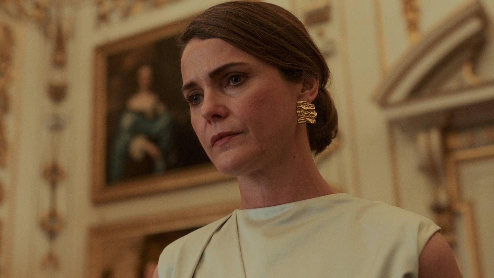 Keri Russell as Kate wearing white and looking down in The Diplomat season 2, episode 6
