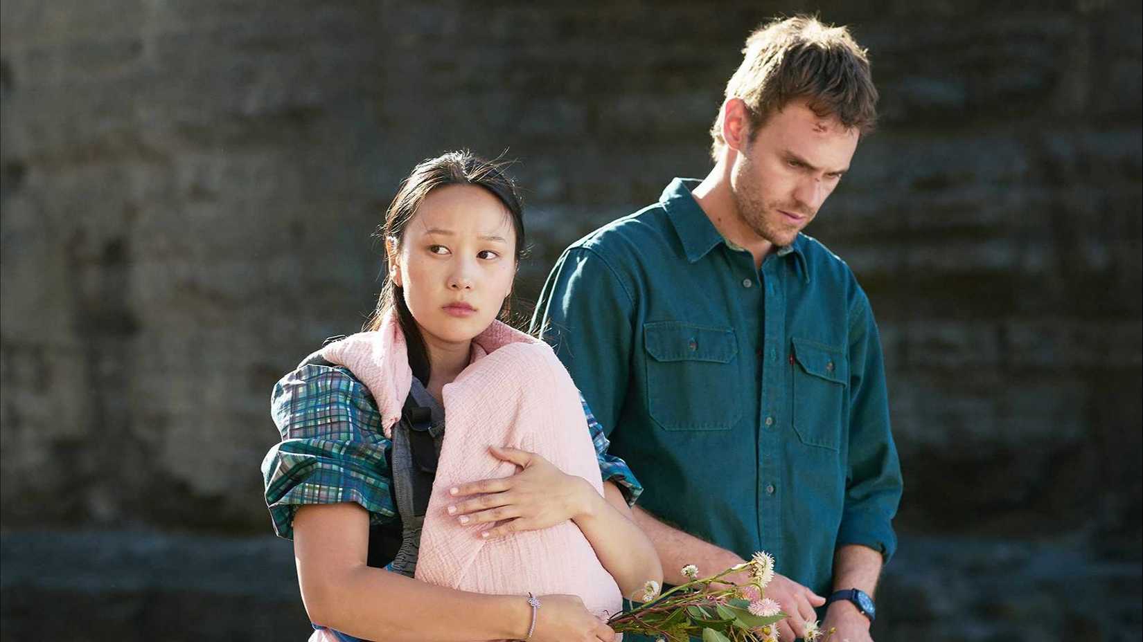 Kieran (Charlie Vickers) and Mia (Yerin Ha) at a memorial in The Survivors.