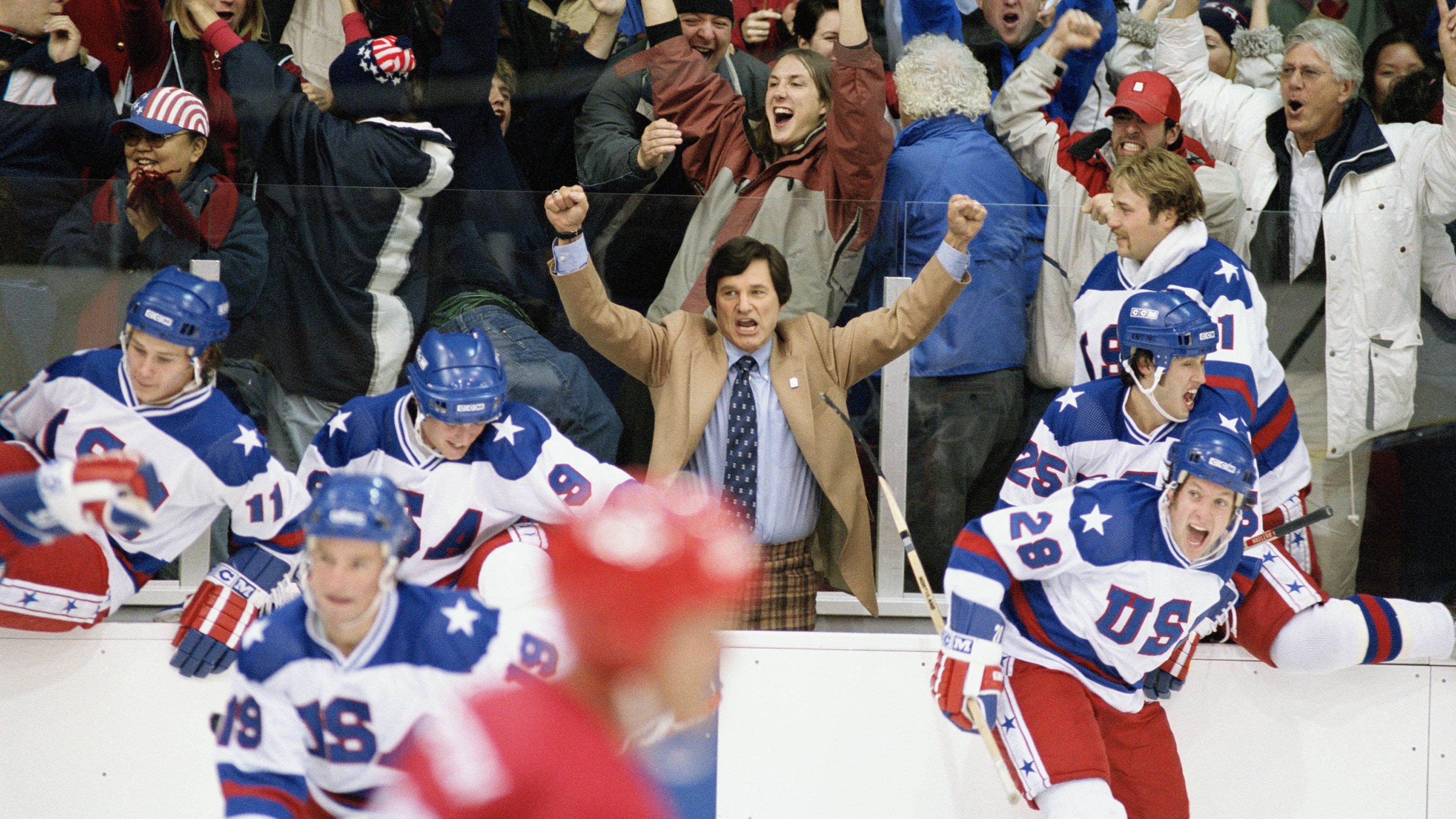 kurt-russell-s-herb-with-his-arms-up-in-celebration-as-the-players-skate-around-in-miracle Kurt Russell’s Iconic 136-Minute Historical Drama Officially Sets New Streaming Release Date