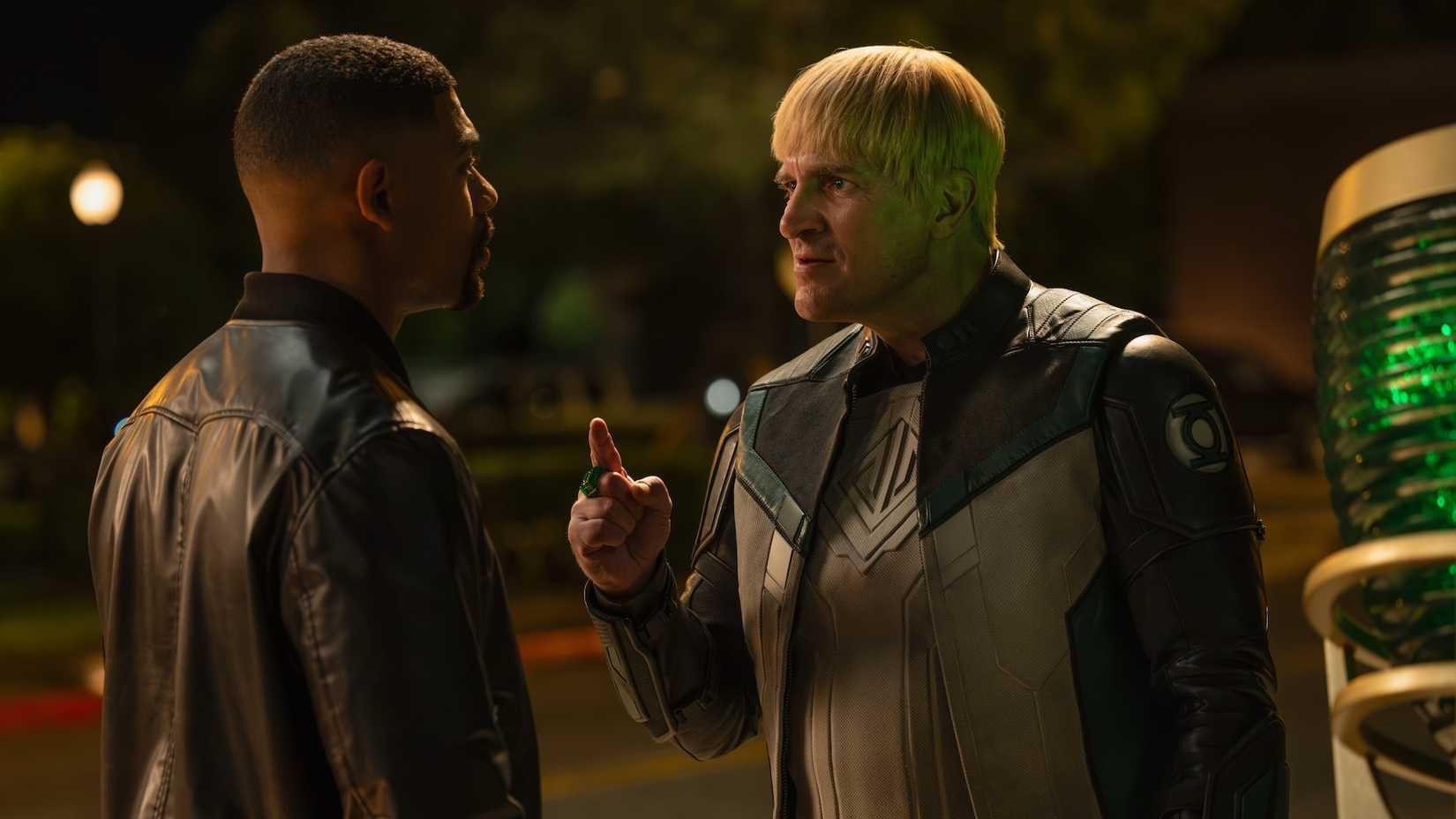 Guy Gardner arguing with John Stewart next to Green Lantern Signal