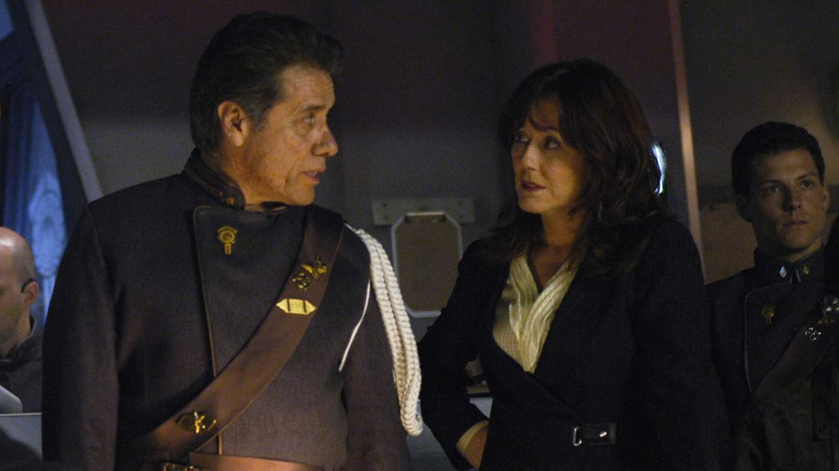 Laura Roslin and Commander William Adama look at each other in Battlestar Galactica