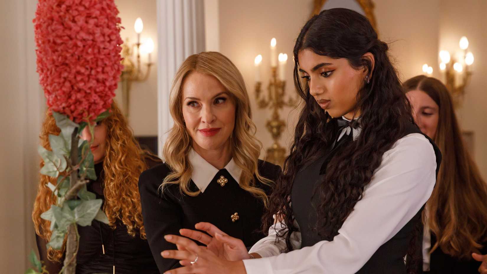 Coco (Leslie Grossman) helping Ophelia (Avantika) perform magic in American Horror Story season 13