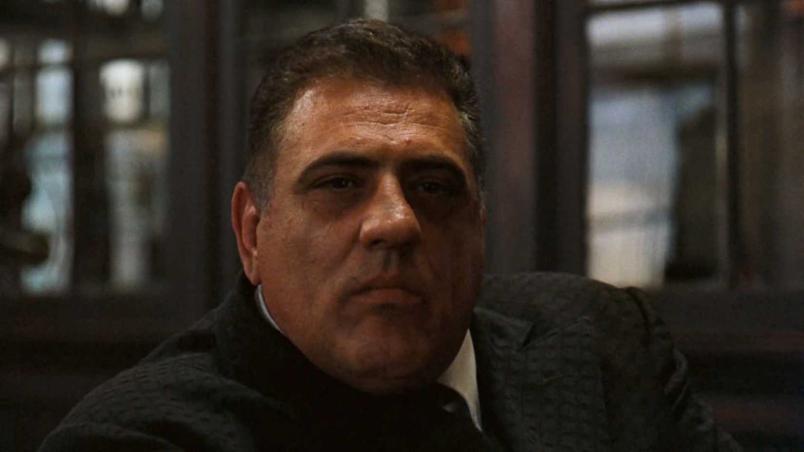 Luca Brasi looks menecaingly into the camera in The godfather