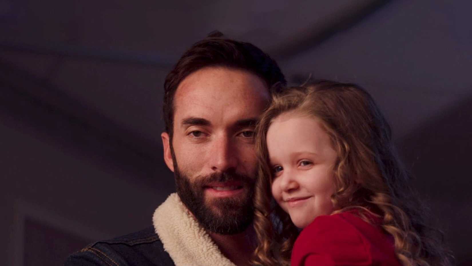 Lucy smiling while her dad carries her in Lucy Shimmers and the Prince of Peace