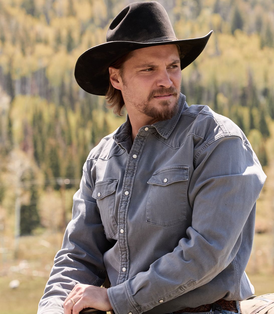Luke Grimes' Kayce sitting atop his horse and looking to the left in Marshals season 2 vertical