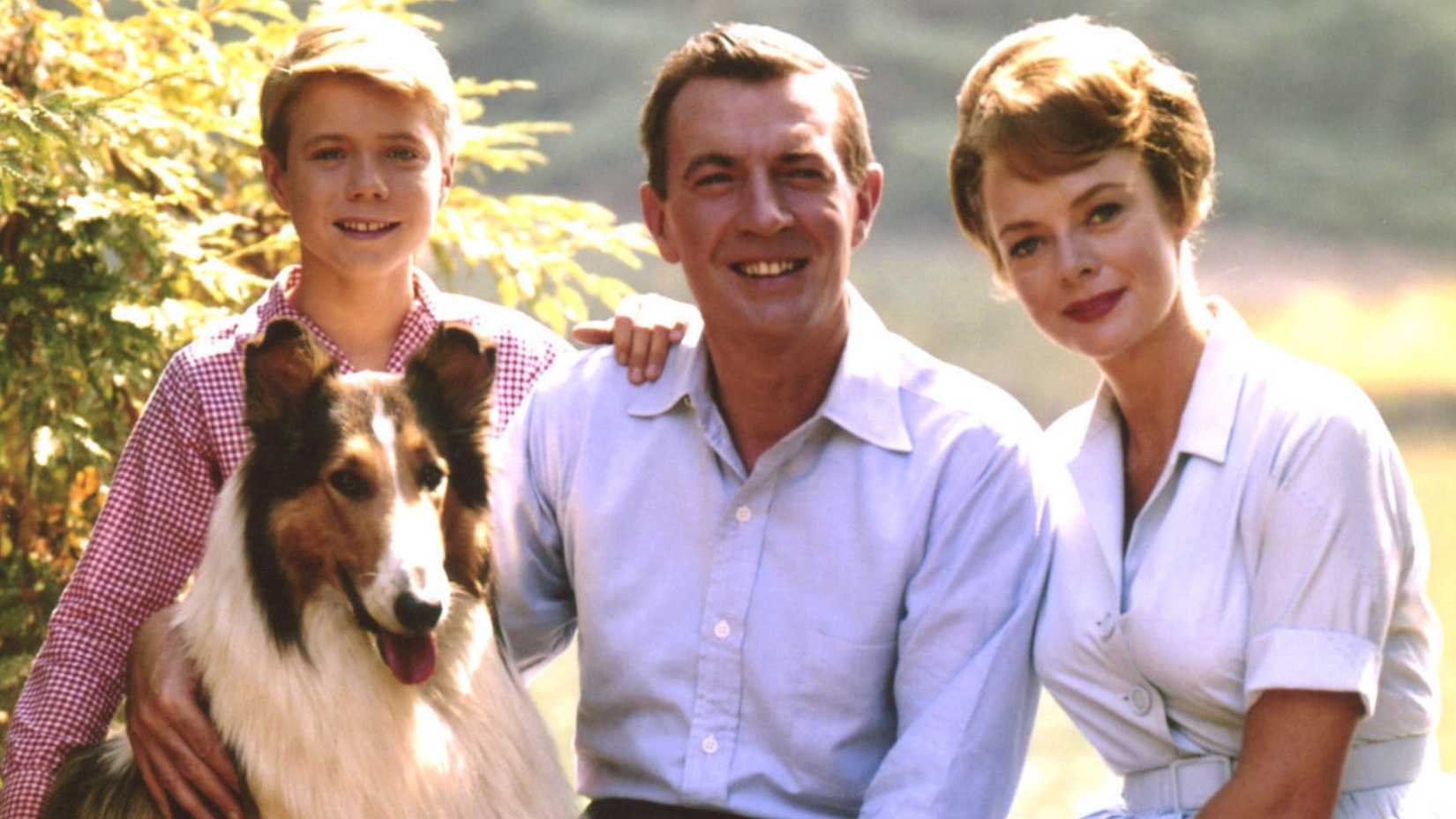 The family gathered around the dog in Lassie