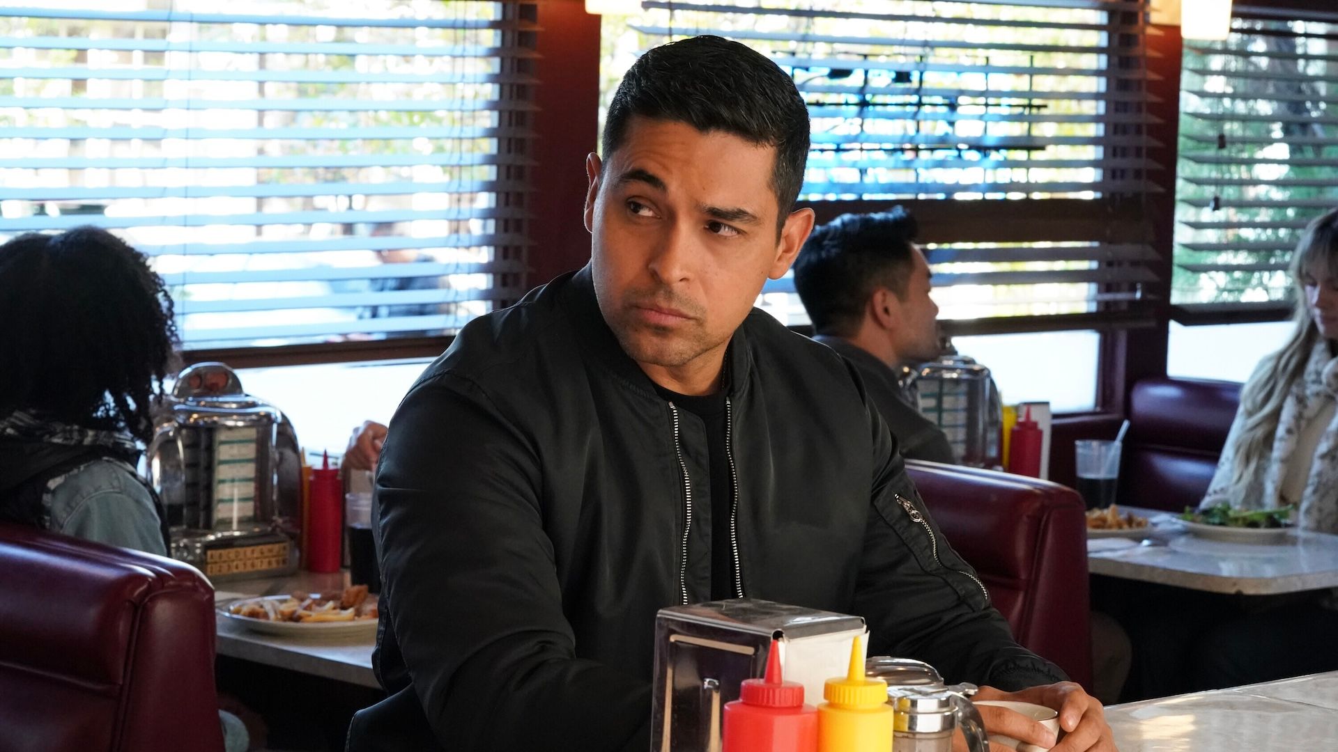 Nick Torres seated at a diner counter