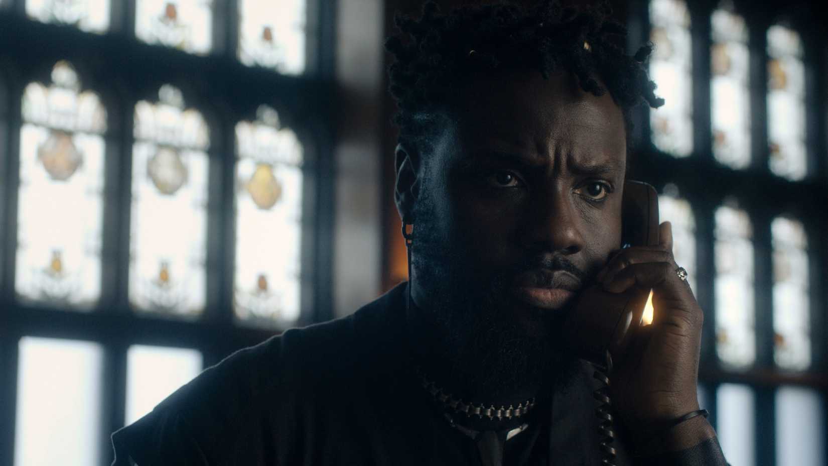 Oluko talks on the phone while looking upset in Dark Matter season 2 episode 10