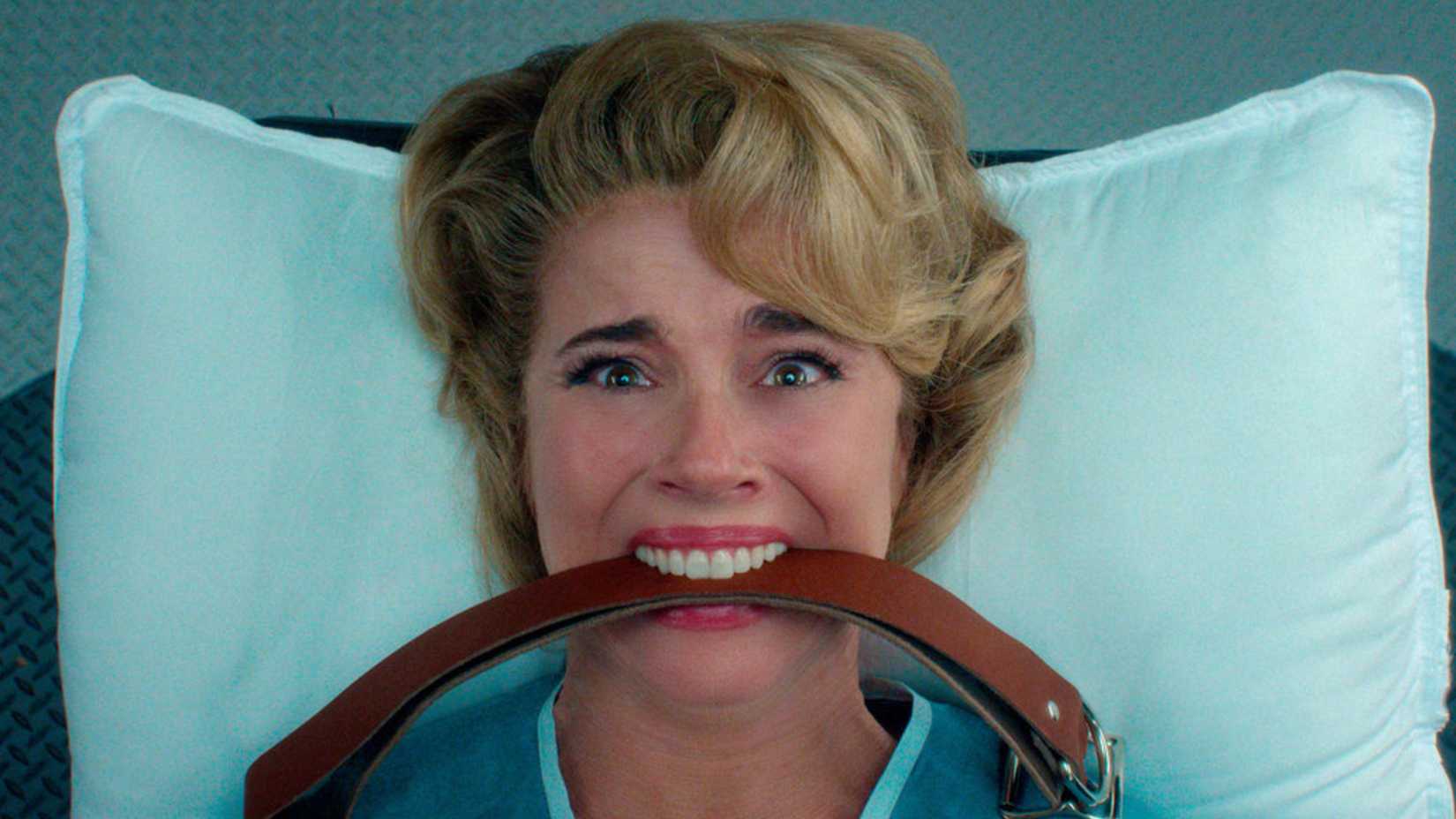 Pamela Voorhees has a leather strap in her mouth while screaming in Crystal Lake episode 7