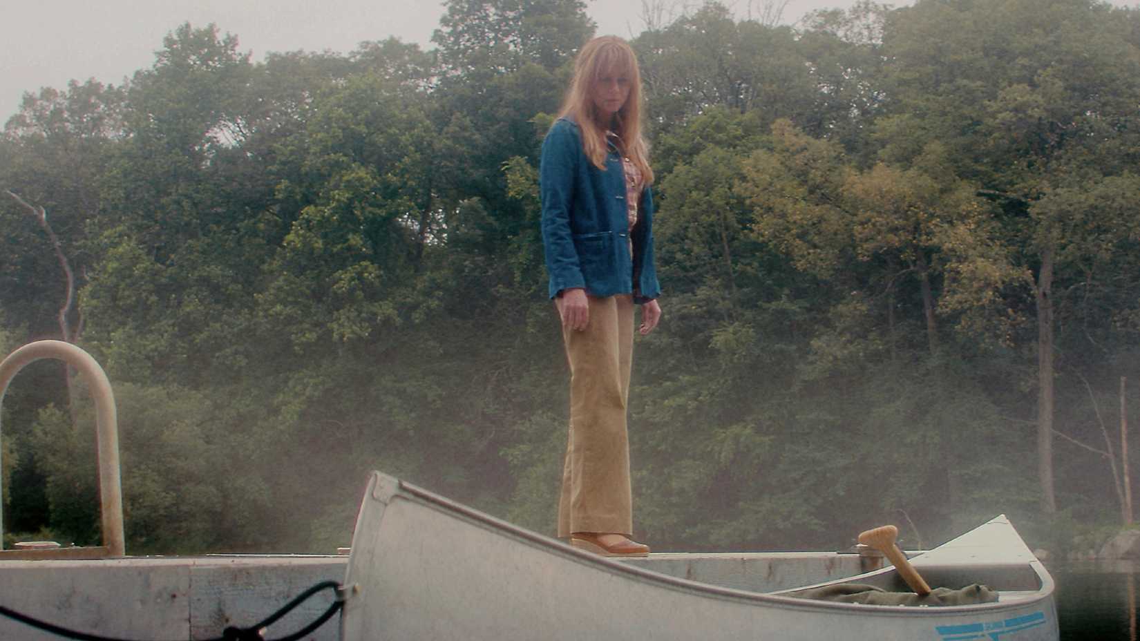 Pamela Voorhees stands on a boat and looks down on the lake in Peacock's Crystal Lake