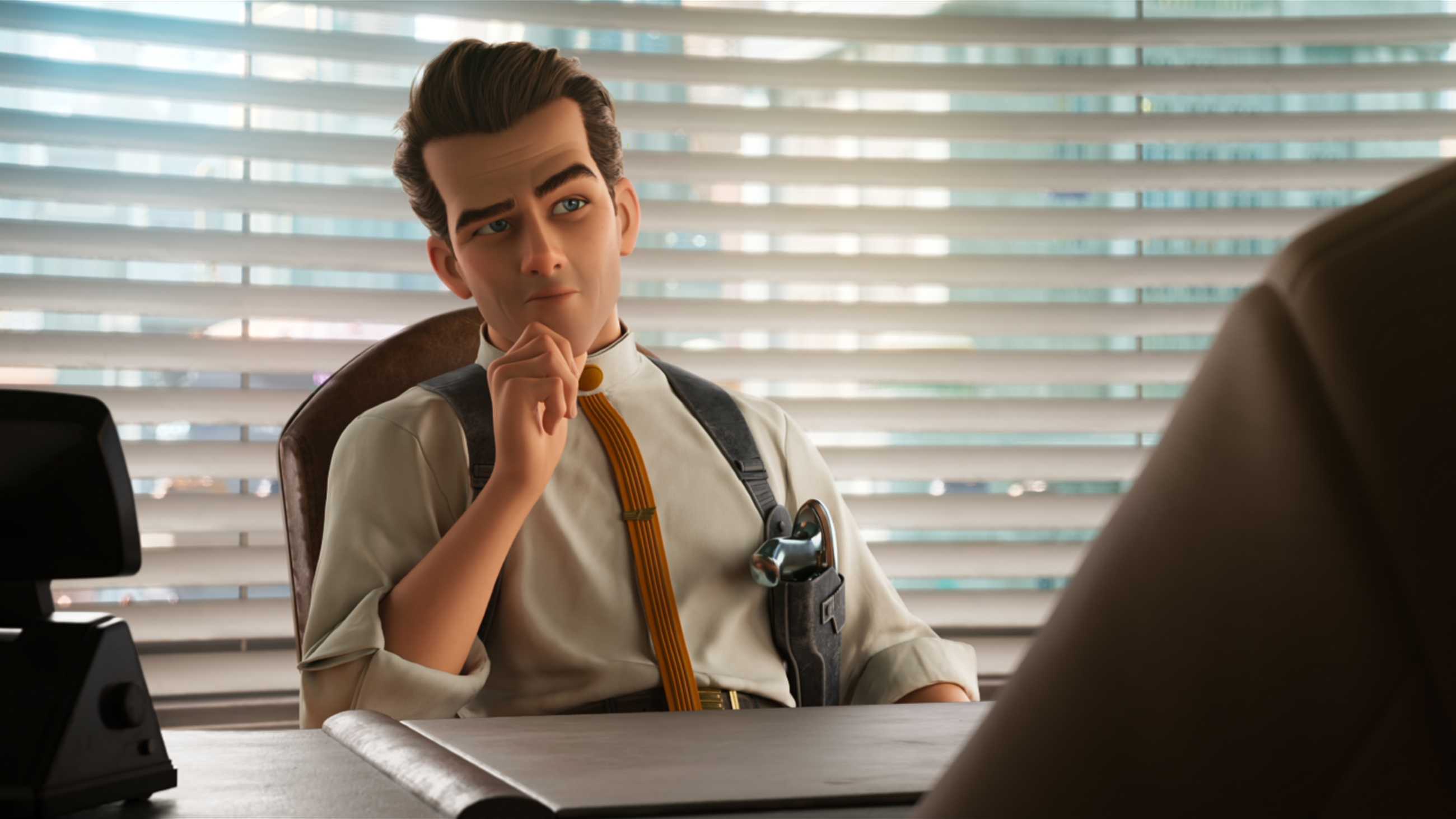 Ray Gunn behind a desk looking intrigued at someone across from him