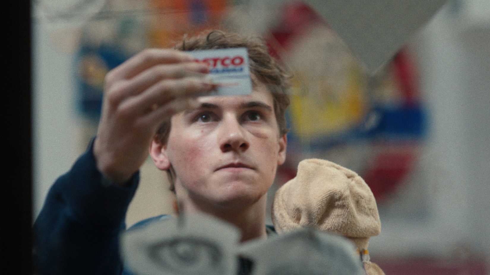 Sam Nivola holding up a Costco card in Phony