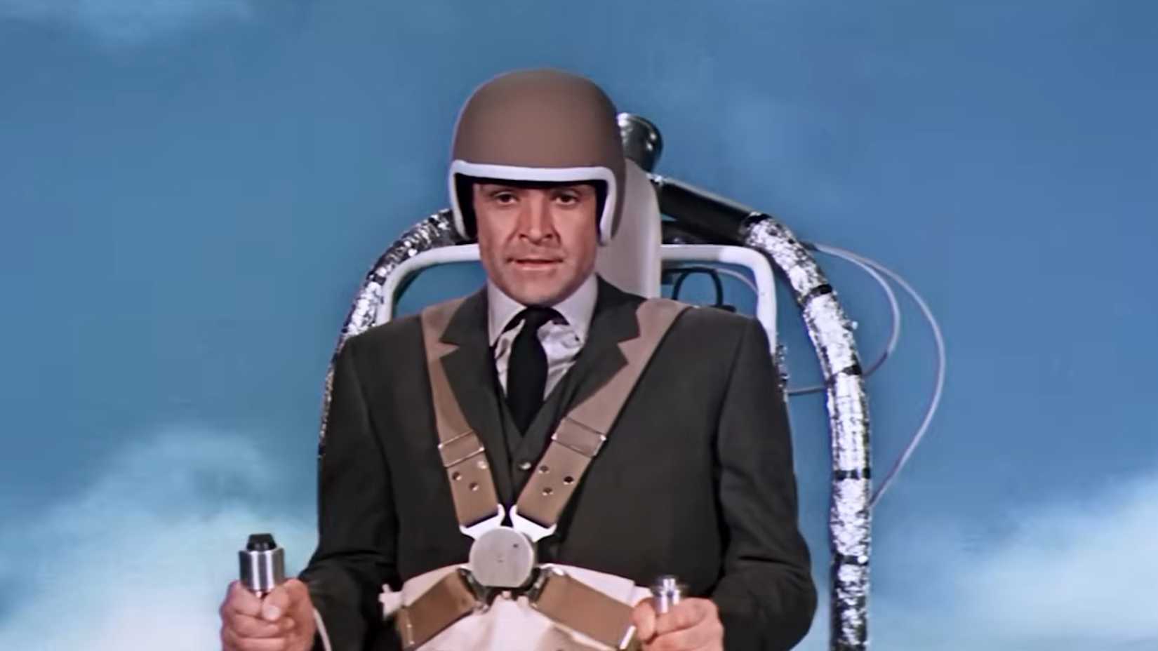 sean connery as 007 wearing a helmet flying a jetpack in thunderball