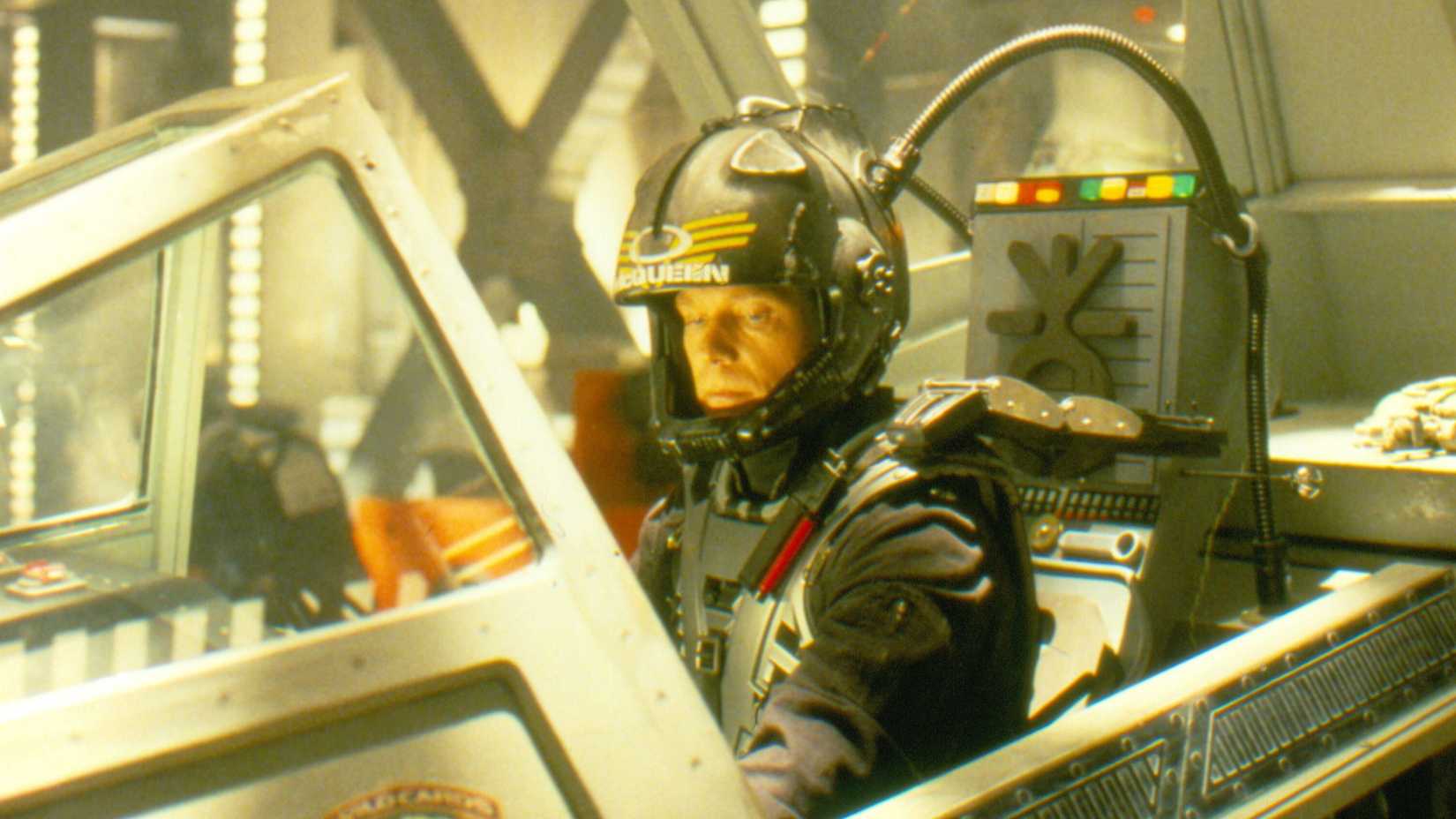 James Morrison as T. C. McQueen sitting in a cockpit looking at his controls in Space: Above and Beyond.