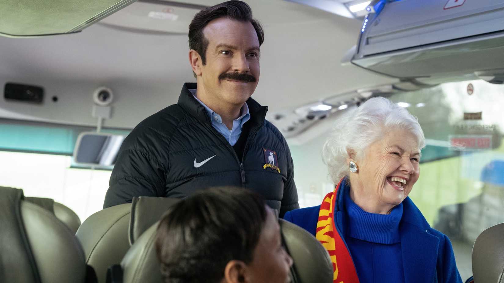 Ted and Mae smiling on the bus in Ted Lasso season 4, episode 9