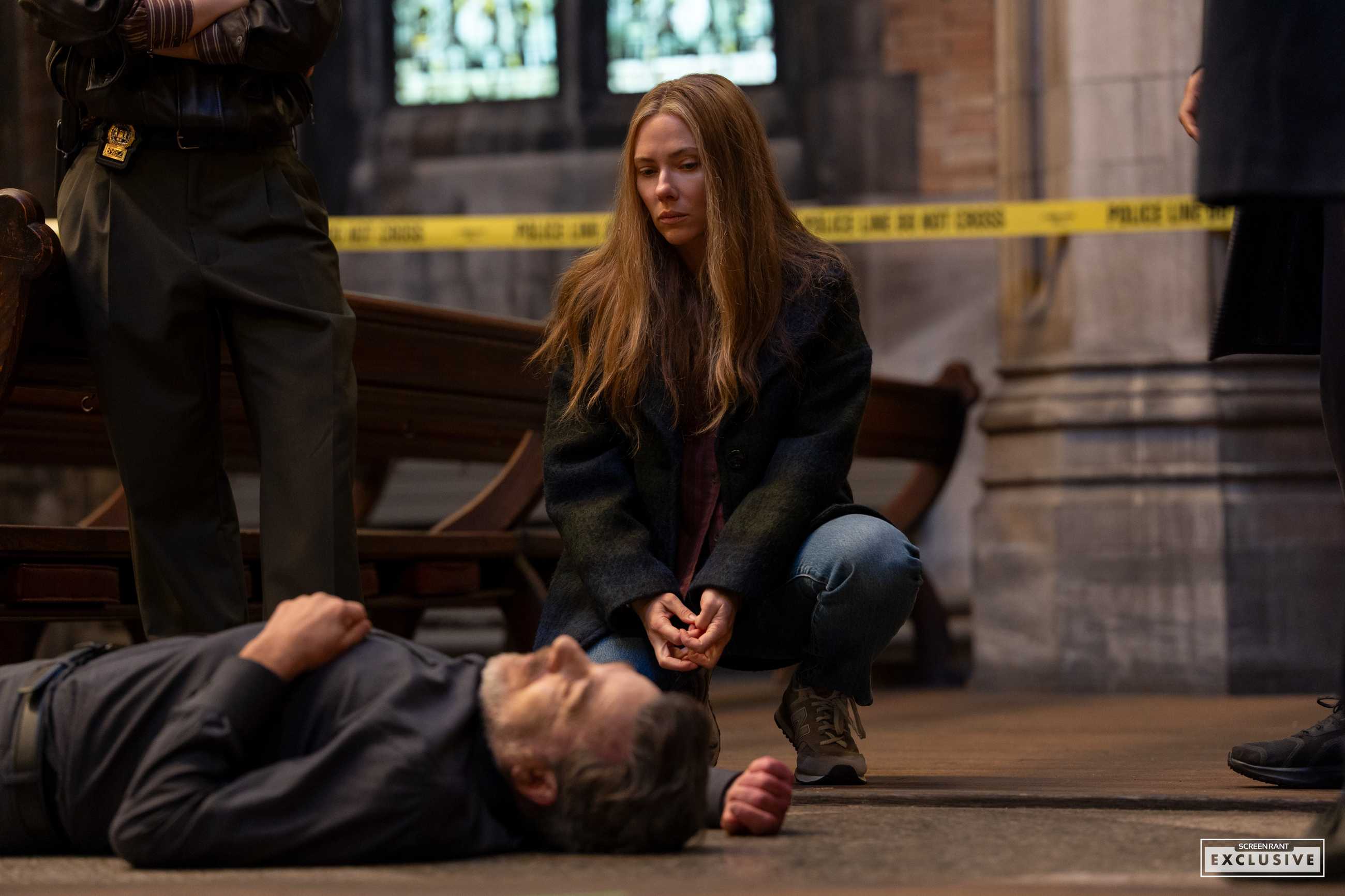 Scarlett Johansson crouching over a body at a crime scene in The Exorcist: Martyrs