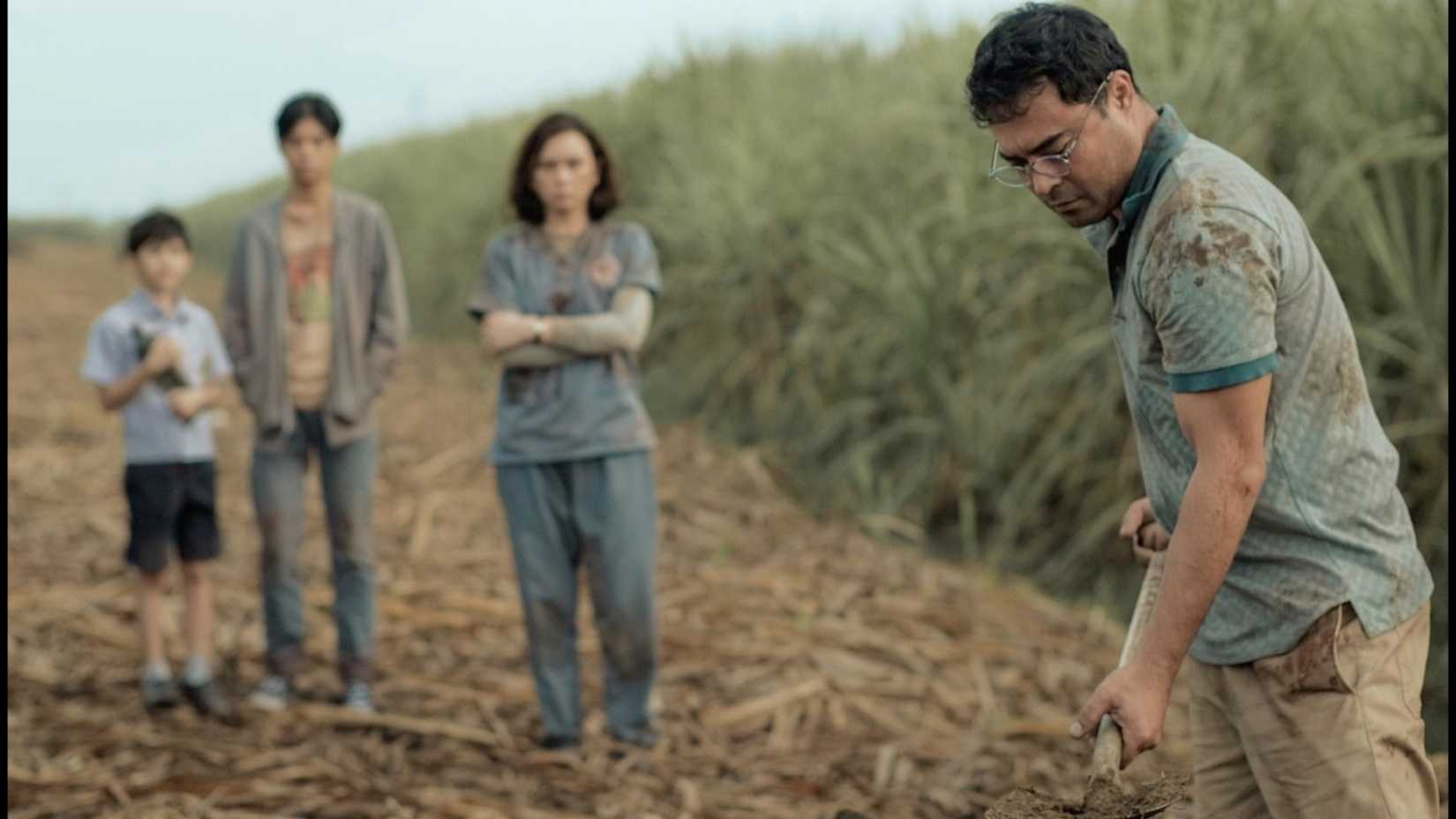 The family dig a grave outside in Outside (2024)