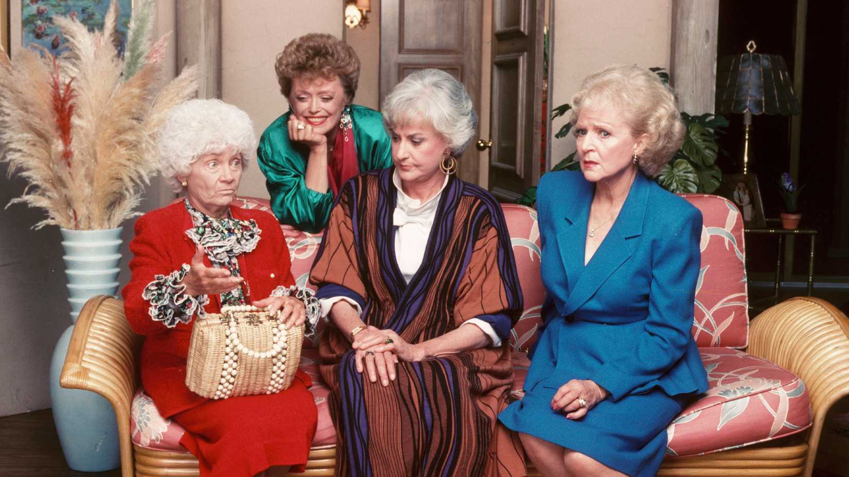 Still of The Golden Girls cast sitting on a couch together.