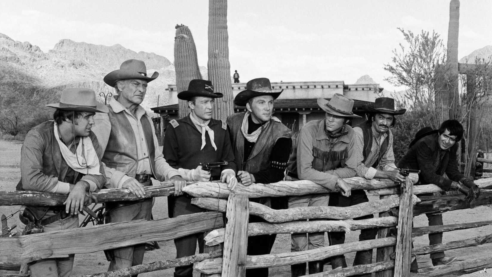 Men leaning on a fence in The High Chaparral