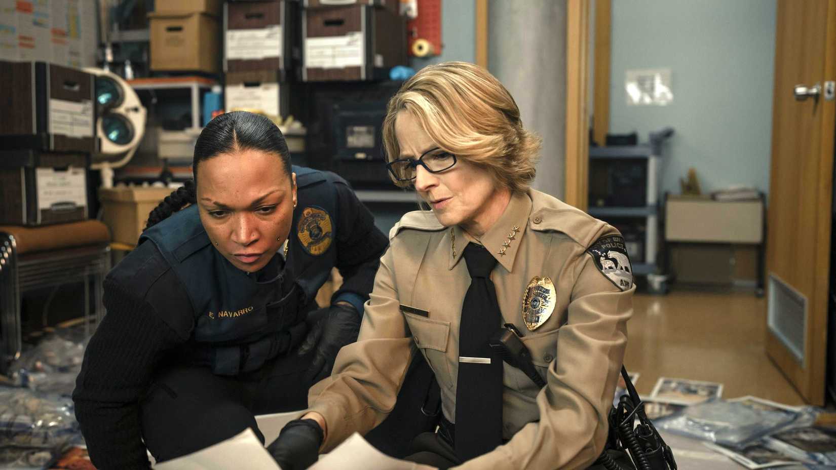 Two characters from True Detective season 4 looking at the notes