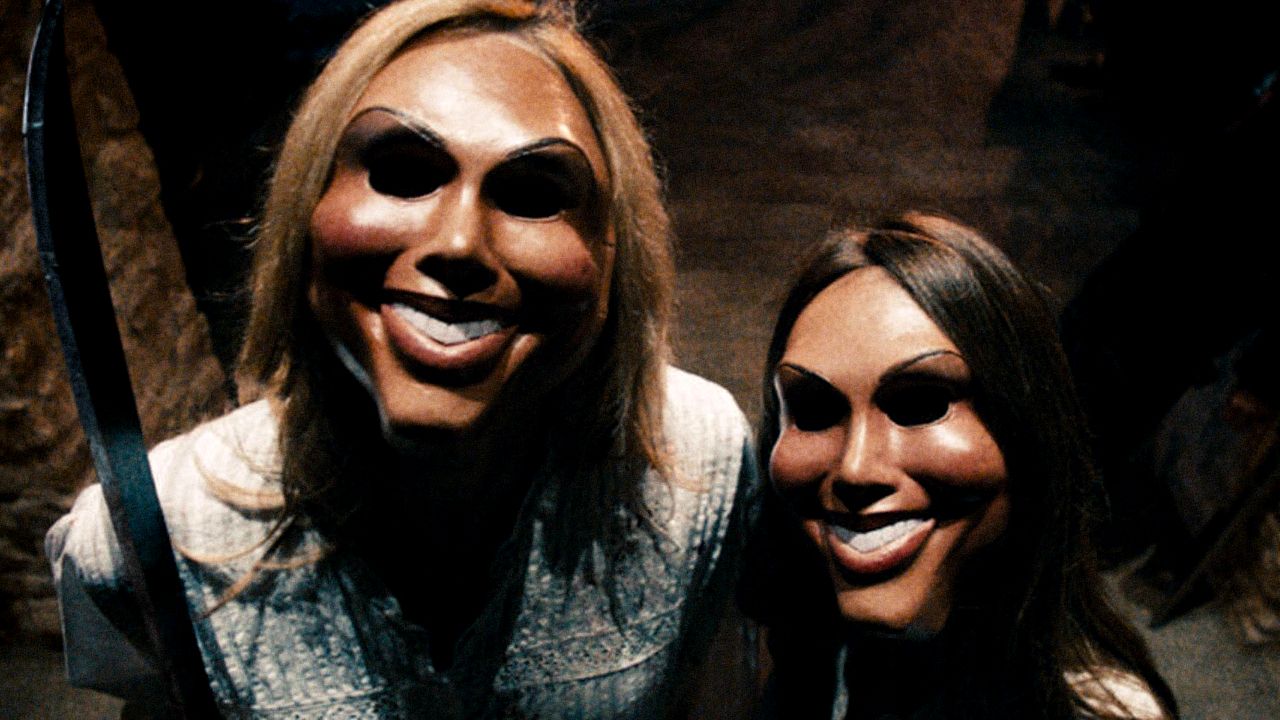 Two Purgers wear masks together in The Purge