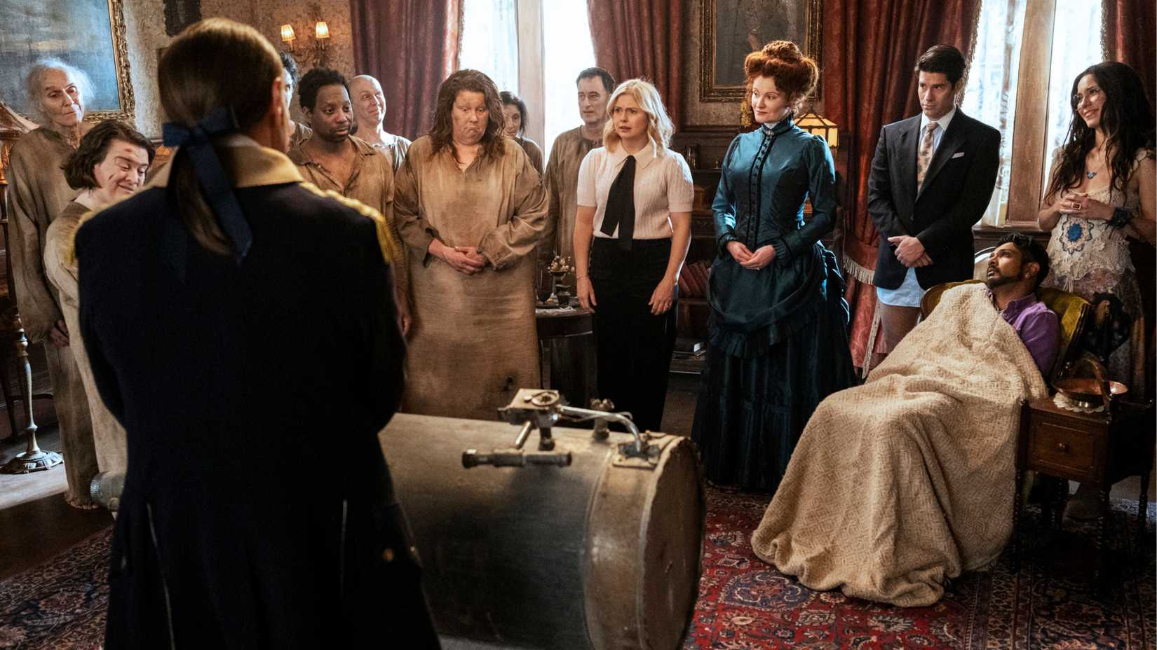Rose McIver as Sam leading the cast of Ghosts