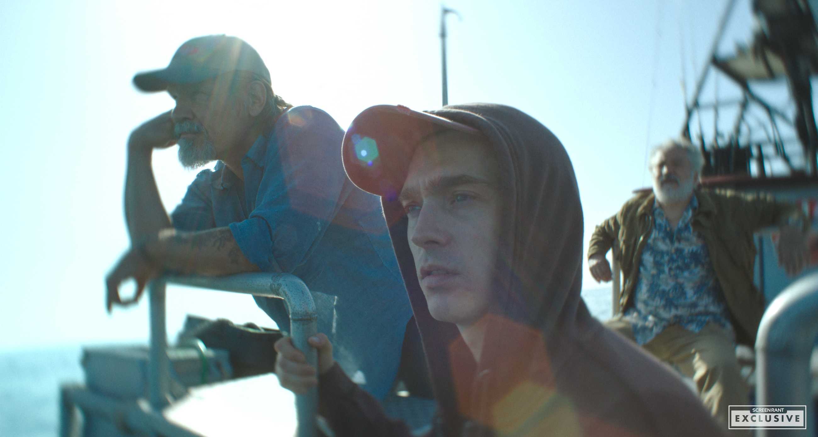 An exclusive still from Whalefall featuring Austin Abrams and Josh Brolin on a boat