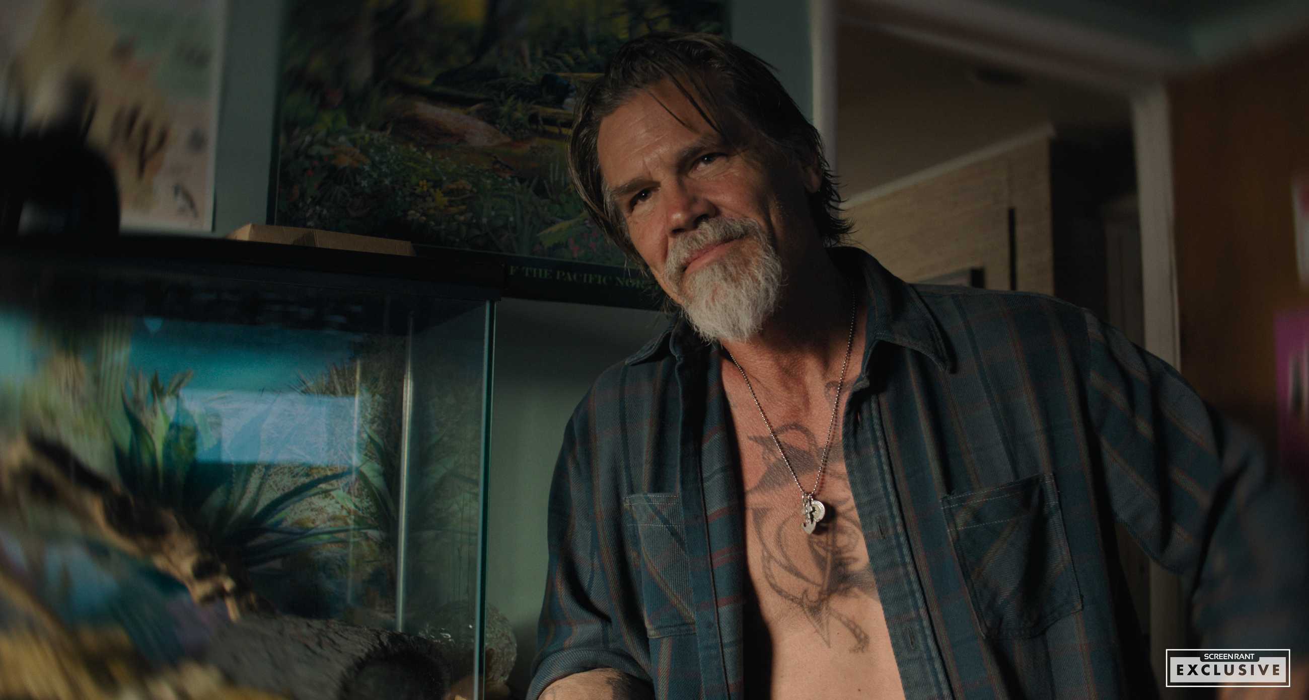 Josh Brolin smiling intensely with his shirt open in Whalefall